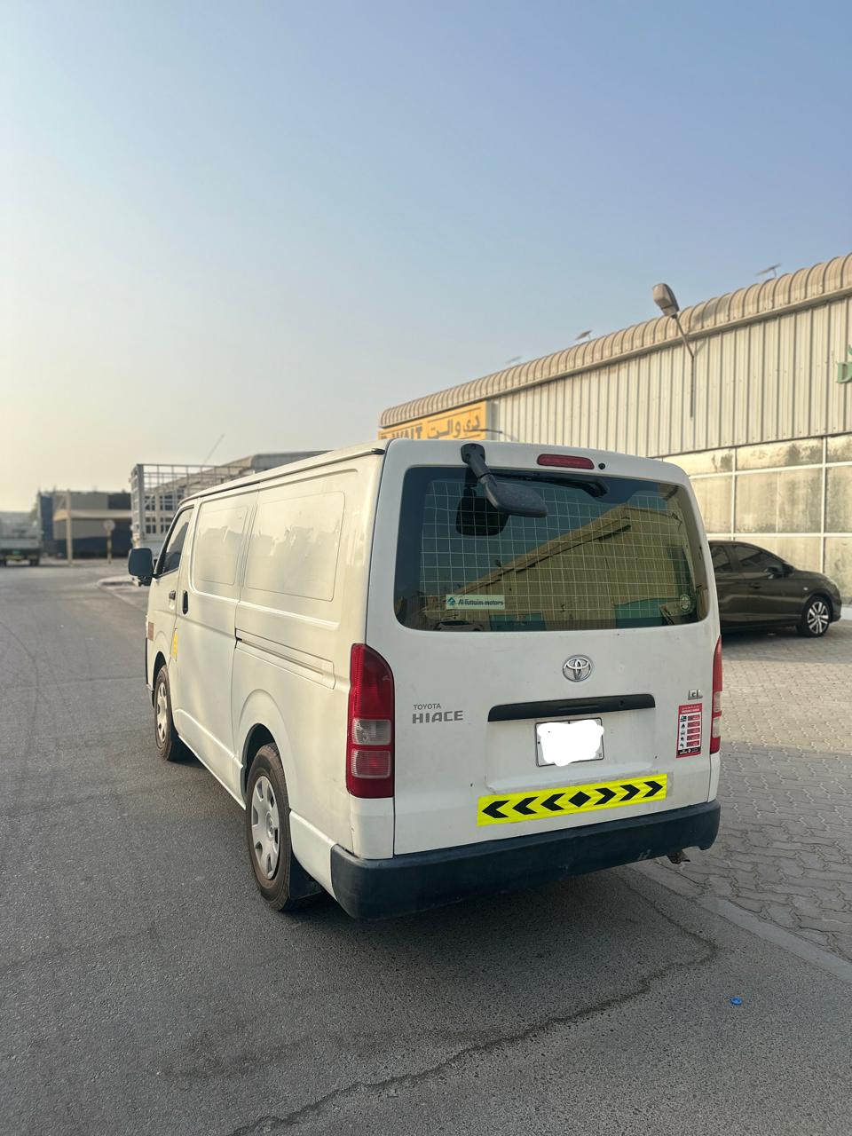 White Toyota Hiace van from Dubai Van Movers, rear view