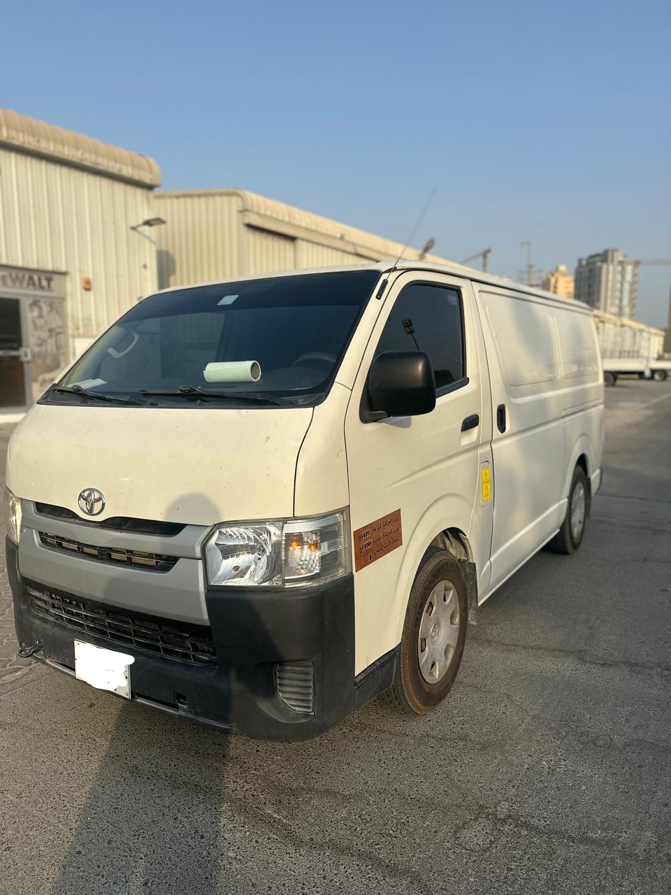 White Toyota Hiace van from Dubai Van Movers, front quarter view