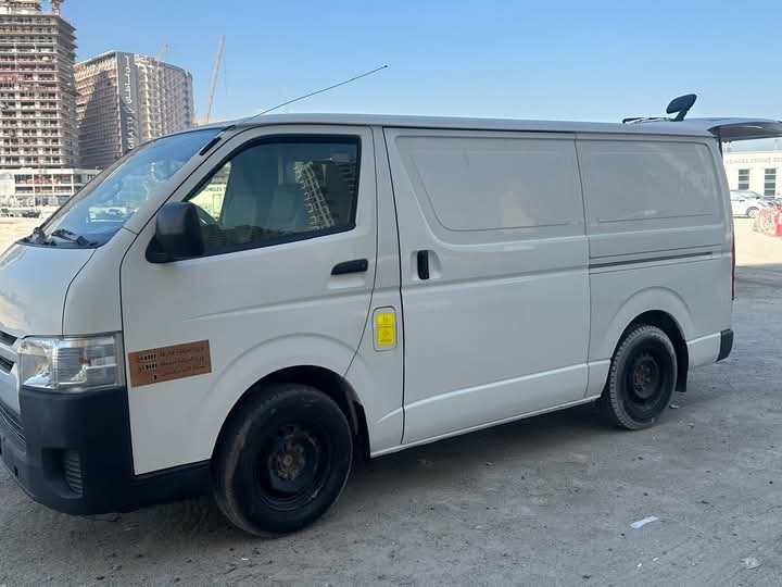 Dubai Van Movers white delivery van parked near a building